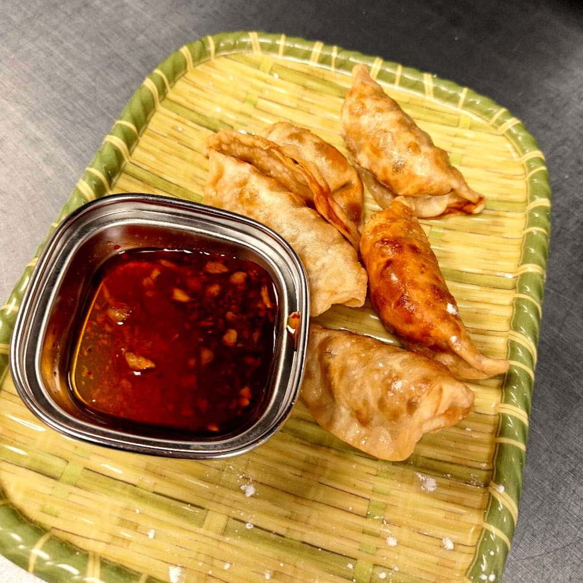 Pan-fried dumplings with chili-garlic dipping sauce at Ombu Grill